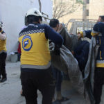 
              This photo provided by the Syrian Civil Defense White Helmets, which has been authenticated based on its contents and other AP reporting, shows Syrian White Helmet civil defense workers carrying a casualty, in the northern town of Ariha, in Idlib province, Syria, Wednesday, Oct. 20, 2021. Rescue workers reported several people were killed, including children and a woman, in  shelling by Syrian government forces on Ariha, in the last rebel enclave in the country's northwest. (Syrian Civil Defense White Helmets via AP)
            