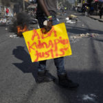 
              A man carries a banner that reads in Creole: "Stop kidnapping. Justice," during a protest organized by friends and relatives of Biana Velizaire who was kidnapped and held for several days by gang members, in Port-au-Prince, Haiti, Monday, Sept. 27, 2021. At least 328 kidnappings were reported to Haiti's National Police in the first eight months of 2021, compared with a total of 234 for all of 2020, according to a report issued last month by the U.N. Integrated Office in Haiti. (AP Photo/Rodrigo Abd)
            