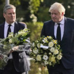 
              British Prime Minister Boris Johnson, right, and Leader of the Labour Party Keir Starmer carry flowers as they arrive at the scene where a member of Parliament was stabbed Friday, in Leigh-on-Sea, Essex, England, Saturday, Oct. 16, 2021. David Amess, a long-serving member of Parliament was stabbed to death during a meeting with constituents at a church in Leigh-on-Sea on Friday, in what police said was a terrorist incident. A 25-year-old man was arrested in connection with the attack, which united Britain's fractious politicians in shock and sorrow. (AP Photo/Alberto Pezzali)
            