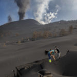 
              People clean up the ash off a house from the volcano in Las Manchas on the Canary island of La Palma, Spain on Thursday Oct. 14, 2021. Hundreds of people in Spain's Canary Islands are fearing for their homes and property after a new lava stream from an erupting volcano threatened to engulf another neighborhood on the island of La Palma. (AP Photo/Saul Santos)
            
