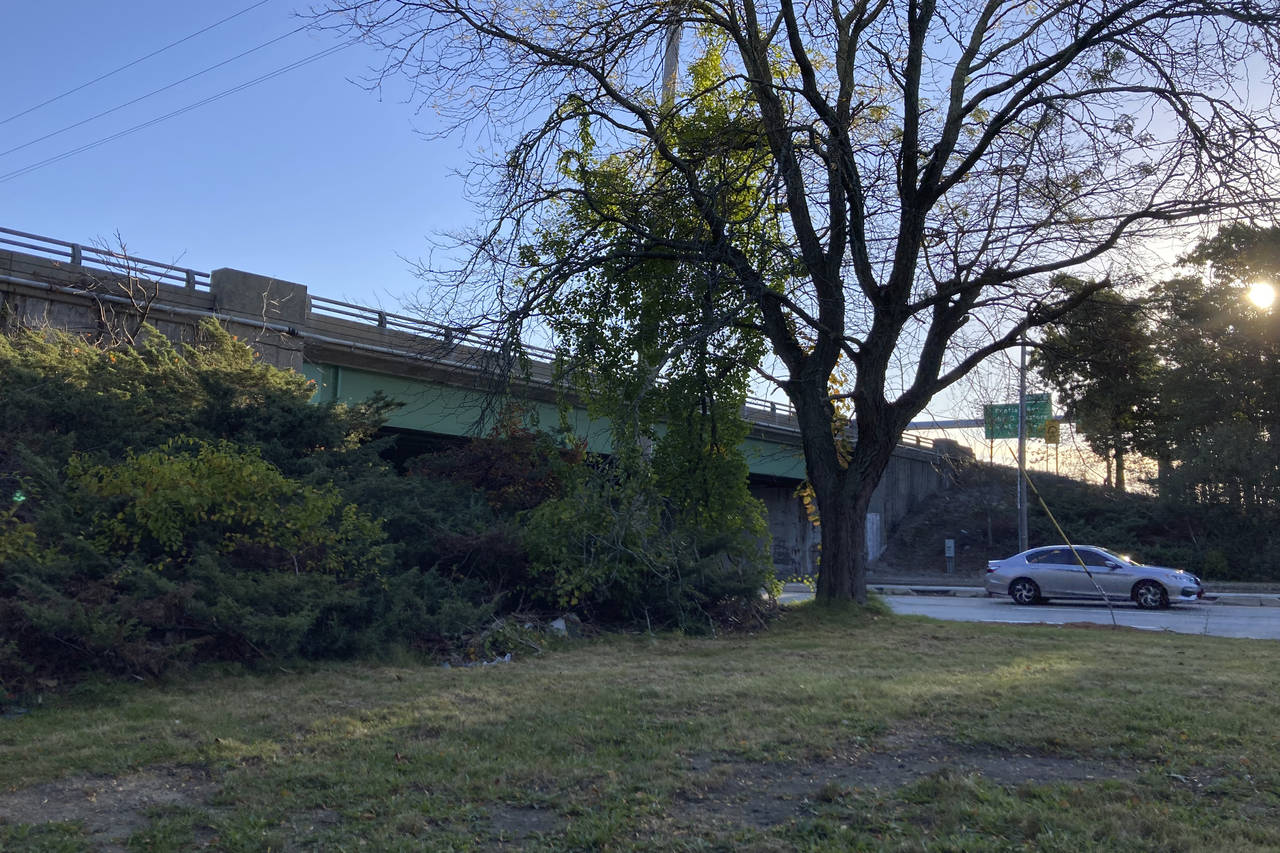 A vehicle passes beneath state Route 37, in Cranston, R.I., early Wednesday, Oct. 20, 2021. Officia...