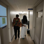 
              A 33-year-old mother of three from central Texas is escorted down the hall by clinic administrator Kathaleen Pittman prior to getting an abortion, Saturday, Oct. 9, 2021, at Hope Medical Group for Women in Shreveport, La. The woman was one of more than a dozen patients who arrived at the abortion clinic, mostly from Texas, where the nation's most restrictive abortion law remains in effect. (AP Photo/Rebecca Blackwell)
            