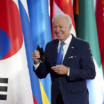 
              U.S. President Joe Biden takes off his protective face mask as he arrives at the La Nuvola conference center for the G20 summit in Rome, Saturday, Oct. 30, 2021. The two-day Group of 20 summit is the first in-person gathering of leaders of the world's biggest economies since the COVID-19 pandemic started. (Kevin Lamarque/Pool Photo via AP)
            