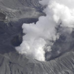 
              Smoke rises from a crater of Mr. Aso, Kumamoto prefecture, southwestern Japan, Wednesday, Oct. 20, 2021. The volcano erupted Wednesday with a massive column of gray smoke billowing into the sky.  (Kyodo News via AP)
            