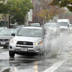 
              A car makes a big splash driving over a puddle on Third Street in San Rafael, Calif. on Thursday, Oct. 21, 2021. Northern California residents delighted by this week's rain were cleaning up Friday and preparing for a massive storm this weekend, happy the precipitation has helped contain stubborn wildfires but fearful of flash flooding in vast areas already scorched by fire. (Sherry LaVars/Marin Independent Journal via AP)
            