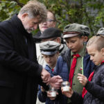 
              School children gather with the mayor and other members of the town during a ceremony commemorating 60 Jews executed in the town during the Holocaust in Wojslawice, Poland, on Thursday Oct. 14, 2021. It is one of many mass grave sites to be discovered in recent years in Poland, which during World War II was occupied by Adolf Hitler’s forces. (AP Photo/Czarek Sokolowski)
            