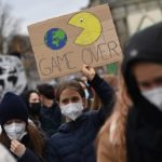 
              A young girl carries a poster reading 'Game over' during climate demonstration of the 'Fridays for Future' movement in Berlin, Germany, Friday, Oct. 22, 2021. (Britta Pedersen/dpa via AP)
            