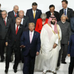 
              FILE - U.S. President Donald Trump, center, walks off with fellow leaders after a family photo session at G-20 leaders summit in Osaka, Japan, on June 28, 2019. The G-20, whose annual summit plays out in Rome this weekend, has morphed from its creation in the 1990s as an international group to grapple with financial crises into a forum facing such pressing problems as worldwide vaccine access and climate change. (Kim Kyung-Hoon/Pool Photo via AP/file)
            
