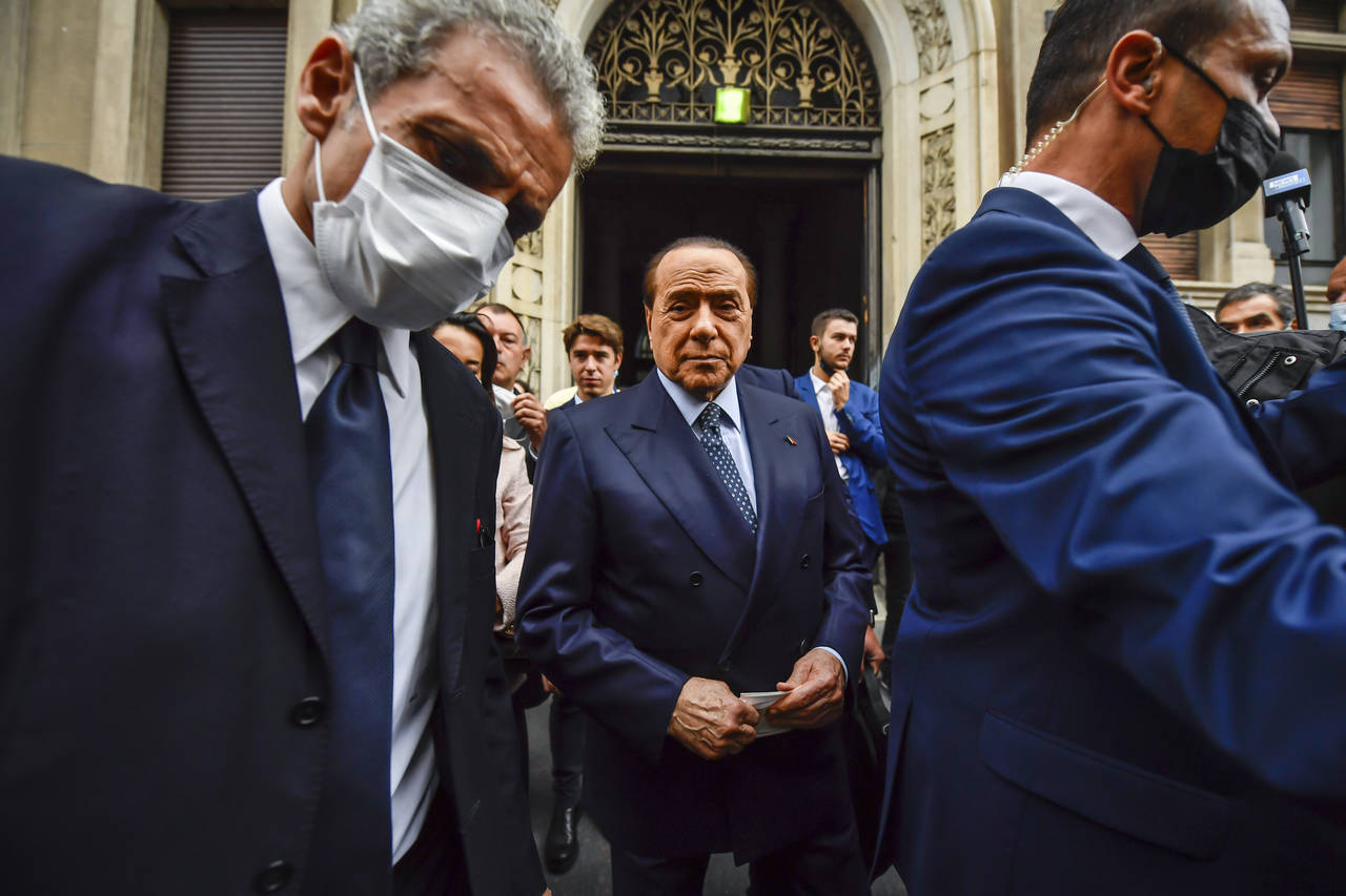FILE - In this Sunday, Oct. 3, 2021 file photo, Silvio Berlusconi leaves a polling station in Milan...