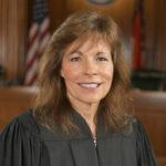 
              This photo provided by North Carolina Administrative Office of the Courts shows Associate Justice Tamara Barringer.  One of several legal challenges to North Carolina’s contentious voter ID law is on hold amid a dispute over whether two justices on the state Supreme Court — one the son of arguably the state's most powerful Republican politician — should recuse themselves.   (North Carolina Administrative Office of the Courts via AP)
            