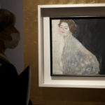 
              A woman admires Gustav Klimt's oil on canvas painting "Portrait of a Lady in White" (1917/18) on display at the exhibition "Klimt. The Secession and Italy" at the Museum of Rome, in Palazzo Braschi, Rome, during a press preview, Tuesday, Oct. 26, 2021. The exhibition, that explores Klimt's period in Italy, will be open to visitors from Oct.27, 2021 to March 27, 2022. (AP Photo/Andrew Medichini)
            