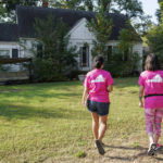 
              In this Saturday, Oct. 16, 2021, photo Han Jones and Lucy Hartman, of Planned Parenthood Advocates of Virginia knock on doors as they canvass the area to encourage voters to vote in Richmond, Va. (AP Photo/Steve Helber)
            