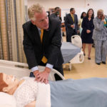 
              FILE - In this July 15, 2021, file photo, Democratic gubernatorial candidate Terry McAuliffe practices his CPR technique during a tour of a nursing training facility at Norfolk State University in Norfolk, Va. McAuliffe won Virginia's 2013 governor's race by embracing his own brand of personal politics that rely on decades-old friendships, back-slapping charisma and tell-it-like-it-is authenticity. (AP Photo/Steve Helber, File)
            