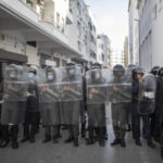 
              Security forces stand guard after dispersing a protest against the government enforcing of a mandatory COVID-19 vaccine pass to access public places and travel, in Rabat, Morocco, Wednesday, Oct. 27, 2021. Morocco's health minister defended the decision and said that the introduction of a vaccine pass had led to a more than fivefold increase in people seeking the jab, as opponents of the measure criticized it in parliament and on the street. (AP Photo/Mosa'ab Elshamy)
            