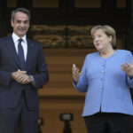 
              Greece's Prime Minister Kyriakos Mitsotakis, left, welcomes Germany's Chancellor Angela Merkel before their meeting at Maximos Mansion in Athens, Greece, Friday, Oct. 29, 2021. Germany's outgoing Chancellor Angela Merkel is on a two-day visit to the country whose financial crisis marked much of her tenure and Germany's relationship with Europe. (AP Photo/Petros Giannakouris)
            
