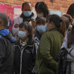 
              Residents wearing face masks to help curb the spread of the coronavirus gather at a vaccination site as they wait to receive booster shots against COVID-19, in Beijing, Monday, Oct. 25, 2021. A northwestern Chinese province heavily dependent on tourism closed all tourist sites Monday after finding new COVID-19 cases. (AP Photo/Andy Wong)
            