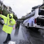 
              Police cordon off a road after a bus transporting oil refinery workers fell into a sink hole in the northern city of Thessaloniki, Greece, Friday, Oct. 15, 2021. Storms continued to batter Greek cities, causing road closures and extensive flooding. (AP Photo/Giannis Papanikos)
            
