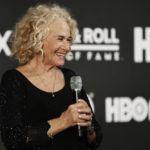 
              Carole King answers questions in the press room during the Rock and Roll Hall of Fame Induction ceremony, Saturday, Oct. 30, 2021, in Cleveland. (AP Photo/Ron Schwane)
            