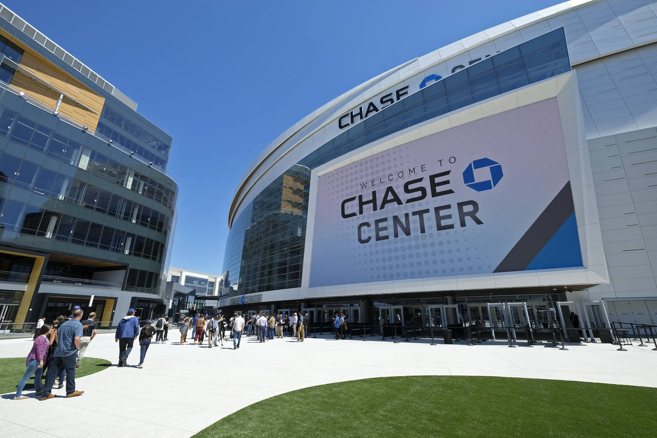 FILE - In this Aug. 26, 2019, file photo, people walk outside the Chase Center in San Francisco. Of...