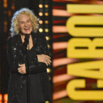 
              Carole King speaks after being inducted in the performer category during the Rock and Roll Hall of Fame Induction ceremony, Saturday, Oct. 30, 2021, in Cleveland. (AP Photo/David Richard)
            