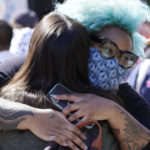 
              Protesters wearing face masks greet outside the Netflix building on Vine Street in the Hollywood section of Los Angeles, Wednesday, Oct. 20, 2021. Critics and supporters of Dave Chappelle's Netflix special and its anti-transgender comments gathered outside the company's offices Wednesday, with "Trans Lives Matter" and "Free Speech is a Right" among their competing messages. (AP Photo/Damian Dovarganes)
            