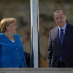 
              German Chancellor Angela Merkel, left, talks to Turkish President Recep Tayyip Erdogan on the occasion of their meeting at Huber Villa presidential palace, in Istanbul, Turkey, Saturday, Oct. 16, 2021. (AP Photo/Francisco Seco)
            