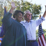 
              Voting rights activist Stacey Abrams, left, waves to the crowd with Democratic gubernatorial candidate, former Virginia Gov. Terry McAuliffe, right, during a rally in Norfolk, Va., Sunday, Oct. 17, 2021. Abrams was in town to encourage voters to vote for the Democratic gubernatorial candidate in the November election. (AP Photo/Steve Helber)
            