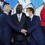 
              U.S. President Joe Biden, left, greets French President Emmanuel Macron, second right, during a group photo at the G20 summit in Rome, Saturday, Oct. 30, 2021. The two-day Group of 20 summit is the first in-person gathering of leaders of the world's biggest economies since the COVID-19 pandemic started. (AP Photo/Evan Vucci, Pool)
            