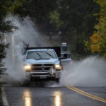 
              A truck passes through floodwaters in Forestville, Calif., on Sunday, Oct. 24, 2021. (AP Photo/Ethan Swope)
            