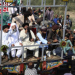 
              Leaders of Tehreek-e-Labiak Pakistan, a radical Islamist party, rally a protest march toward Islamabad, on a highway in the town of Sadhuke, in eastern Pakistan, Wednesday, Oct. 27, 2021. Violence at the anti-France Islamist rally in Sadhuke left at least one police officer and two demonstrators dead. ​They demanded the expulsion of France's envoy to Pakistan over publication of caricatures of Islam's Prophet Muhammad in France. (AP Photo/K.M. Chaudary)
            