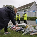 
              A woman places a floral tribute on the road leading to the Belfairs Methodist Church in Eastwood Road North, in Leigh-on-Sea, Essex, England, Saturday, Oct. 16, 2021. David Amess, a long-serving member of Parliament was stabbed to death during a meeting with constituents at a church in Leigh-on-Sea on Friday, in what police said was a terrorist incident. A 25-year-old man was arrested in connection with the attack, which united Britain's fractious politicians in shock and sorrow. (AP Photo/Alberto Pezzali)
            