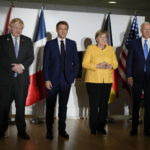 
              British Prime Minister Boris Johnson, French President Emmanuel Macron, German Chancellor Angela Merkel, and U.S. President Joe Biden, from left, pose for the media prior to a meeting at the La Nuvola conference center for the G20 summit in Rome, Saturday, Oct. 30, 2021. The two-day Group of 20 summit is the first in-person gathering of leaders of the world's biggest economies since the COVID-19 pandemic started. (AP Photo/Kirsty Wigglesworth, Pool)
            