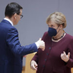 
              Poland's Prime Minister Mateusz Morawiecki, left, speaks with German Chancellor Angela Merkel during a round table meeting at an EU summit in Brussels, Friday, Oct. 22, 2021. European Union leaders conclude a two-day summit on Friday in which they discussed issues such as climate change, the energy crisis, COVID-19 developments and migration.(AP Photo/Olivier Matthys, Pool)
            