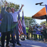 
              Voting rights activist Stacey Abrams, left, waves to the crowd with Democratic gubernatorial candidate, former Virginia Gov. Terry McAuliffe, right, during a rally in Norfolk, Va., Sunday, Oct. 17, 2021. Abrams was in town to encourage voters to vote for the Democratic gubernatorial candidate in the November election. (AP Photo/Steve Helber)
            