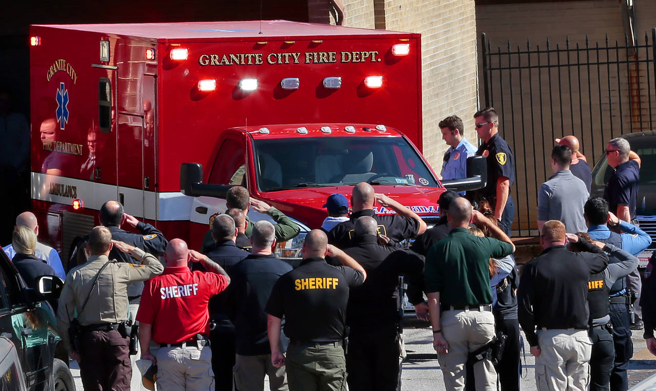 The body of Pontoon Beach police officer Tyler Timmins arrives at the St. Louis medical examiner's ...