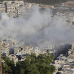 
              This photo provided by the Syrian Civil Defense White Helmets, which has been authenticated based on its contents and other AP reporting, shows smoke rising from Syrian government shelling on the northern town of Ariha, in Idlib province, Syria, Wednesday, Oct. 20, 2021. Rescue workers reported several people were killed, including children and a woman, in the shelling of Ariha, a town in the last rebel enclave in the country's northwest. (Syrian Civil Defense White Helmets via AP)
            