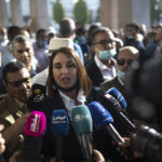
              Parliament member Nabila Mounib speaks to the press during a protest against the government enforcing of a mandatory COVID-19 vaccine pass to access public places and travel, in Rabat, Morocco, Wednesday, Oct. 27, 2021. Morocco's health minister defended the decision and said that the introduction of a vaccine pass had led to a more than fivefold increase in people seeking the jab, as opponents of the measure criticized it in parliament and on the street. (AP Photo/Mosa'ab Elshamy)
            