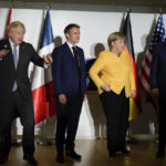 
              British Prime Minister Boris Johnson, French President Emmanuel Macron, German Chancellor Angela Merkel, and U.S. President Joe Biden, from left, pose for the media prior to a meeting at the La Nuvola conference center for the G20 summit in Rome, Saturday, Oct. 30, 2021. The two-day Group of 20 summit is the first in-person gathering of leaders of the world's biggest economies since the COVID-19 pandemic started. (AP Photo/Kirsty Wigglesworth, Pool)
            