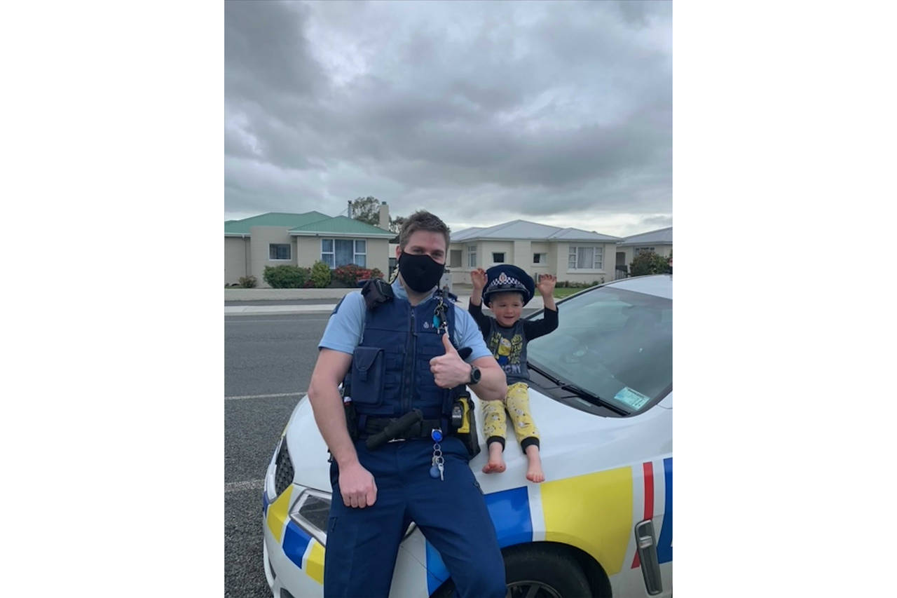 In this photo released by New Zealand Police, an officer identified only as Constable Kurt sits on ...