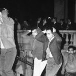 
              FILE - In this Oct.17, 1967 file photo, Algerians come out of Paris subway station with their hands on their heads after being arrested in Paris for failure to obey curfew imposed on Algerians. A tribute march is organized in Paris Sunday Oct.17, 2021 for the 60th anniversary of the bloody police crackdown on a protest by Algerians in the French capital, during the final year of their country's independence war with the colonial power. About 12,000 Algerians were arrested and "several dozens" were killed, "their bodies thrown into the Seine River." Historians say at least 120 protesters have been killed, some shot and some drowned in the Seine River. (AP Photo, File)
            