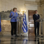 
              German Chancellor Angela Merkel, speaks next to Greece's Prime Minister Kyriakos Mitsotakis, during a join news conference and after their meeting at Maximos Mansion in Athens, Greece, Friday, Oct. 29, 2021. Germany's outgoing Chancellor Angela Merkel is on a two-day visit to the country whose financial crisis marked much of her tenure and Germany's relationship with Europe. (AP Photo/Thanassis Stavrakis)
            