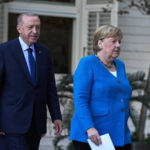 
              German Chancellor Angela Merkel, right, and Turkish President Recep Tayyip Erdogan arrive for a joint news conference following their meeting at Huber Villa presidential palace, in Istanbul, Turkey, Saturday, Oct. 16, 2021. The leaders discussed Ankara's relationship with Germany and the European Union as well as regional issues including Syria and Afghanistan. (AP Photo/Francisco Seco)
            