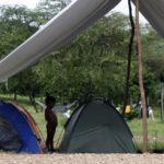 
              A child stands between pitched tents at a shelter in Lajas Blancas, Darien, Panama, Saturday, Oct. 23, 2021. A rising number of female migrants have reported suffering sexual abuse while crossing the treacherous Darien Gap between Colombia and Panama. Seeking to draw attention to the issue, a group of Panamanian lawmakers travelled Saturday on a fact-finding mission to speak with victims and authorities in the remote province. (AP Photo/Ana Renteria)
            