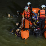 
              Rescuers search for victims of drowning in a river in Ciamis, West Java, Indonesia, Friday, Oct. 15, 2021. A number of students drowned during a school outing for a river cleanup on Friday evening in Indonesia's West Java Province. (AP Photo/Yopi Andrias)
            