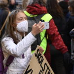 
              Activist Greta Thunberg takes a picture during a "global climate strike" demonstration, organized by Fridays For Future in central Stockholm, Friday, Oct. 22, 2021. (Erik Simander/TT via AP)
            