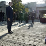 
              French President Emmanuel Macron stands at attention after laying a wreath near the Pont de de Bezons (Bezons bridge) Saturday, Oct. 16, 2021 in Colombes near Paris. Emmanuel Macron becomes the first French president to commemorate the brutal repression of an Oct 17, 1961 demonstration during which at least 120 Algerians were killed during a protest to support Algerian independence. The bridge was borrowed 60 years ago by Algerian demonstrators who arrived from the neighboring slum de Nanterre at the call of the Algerian independence supporters based in France. (AP Photo/Rafael Yaghobzadeh, Pool)
            