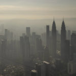 
              This aerial image taken with a drone shows a general view of Kuala Lumpur city, Malaysia, early Sunday, Oct. 10, 2021. (AP Photo/Terence Tan)
            