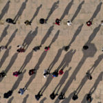 
              This photo released by Xinhua News Agency shows an aerial view of residents lining up to receive a swab for the coronavirus test during a mass testing in Xingqing District of Yinchuan in northwest China's Ningxia Hui Autonomous Region Saturday, Oct. 23, 2021. China's Gansu has closed all tourist sites following the reporting of new COVID-19 cases in the northwestern province. Gansu lies along the ancient Silk Road and is famed for the Dunhuang grottoes filled with Buddhist images and other ancient religious sites. (Wang Peng/Xinhua via AP)
            