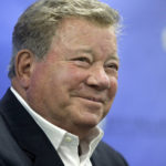 FILE - In this May 6, 2018 file photo, actor William Shatner takes questions from reporters after delivering the commencement address at New England Institute of Technology graduation ceremonies, in Providence, R.I. Star Trek's Captain Kirk is rocketing into space this month -- boldly going where no other sci-fi actors have gone. Jeff Bezos' space travel company, Blue Origin, announced Monday, Oct. 4, 2021 that Shatner will blast off from West Texas on Oct. 12.  (AP Photo/Steven Senne, file)