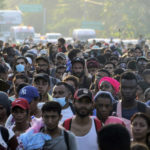 
              A caravan of migrants, mostly from Central America, head north along coastal highway just outside of Huehuetan at Chiapas State, Mexico, on Sunday, October 24, 2021. (AP Photo / Marco Ugarte)
            